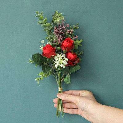 Cette image montre un bouquet de roses artificielles de couleur rouge
