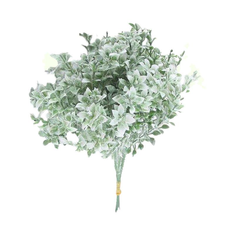 Cette image montre un bouquet de fleurs artificielles de couleur verte