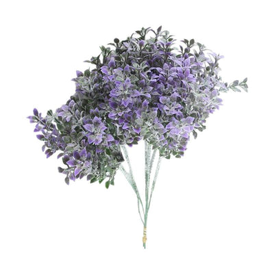 Cette image montre un bouquet de fleurs artificielles de couleur violette