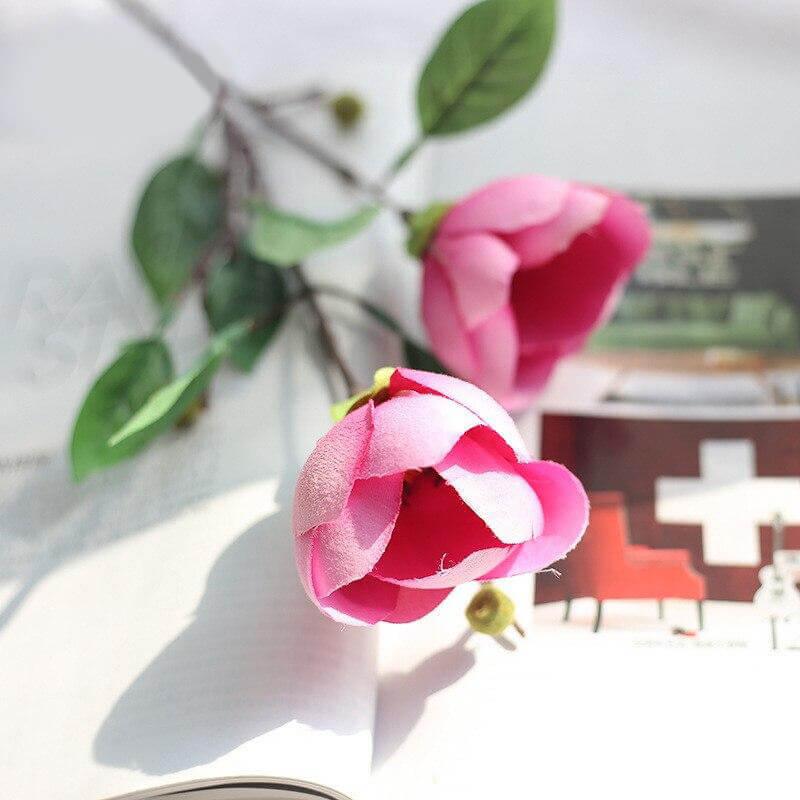 Cette image montre une fleur artificielle rose. cette fausse fleur est une magnolia. Fleur artificielle cimetière